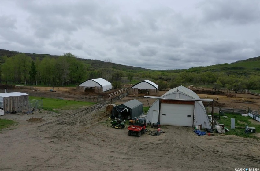 View of front facade with a rural view, an outdoor structure, and a garage