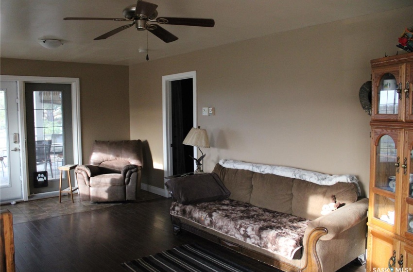 Living room with hardwood / wood-style floors and ceiling fan