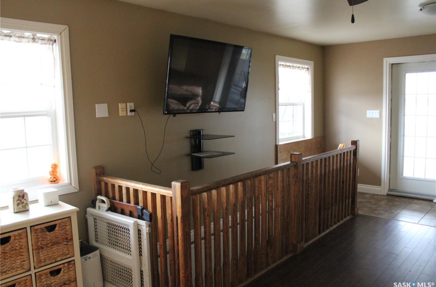 Living room featuring a wealth of natural light and dark hardwood / wood-style flooring