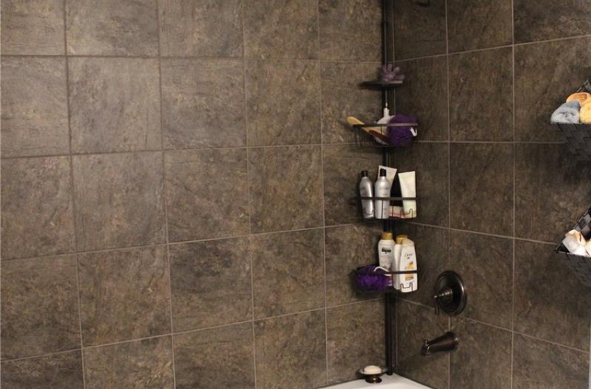 Bathroom with tiled shower / bath combo and tile patterned floors