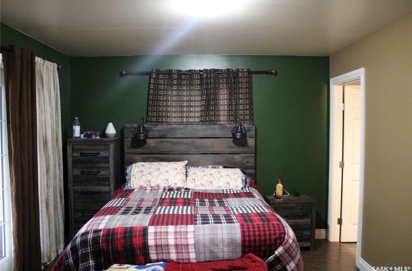 Bedroom with dark hardwood / wood-style floors