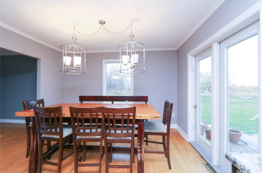 Dining space featuring an inviting chandelier, light hardwood / wood-style flooring, and ornamental molding