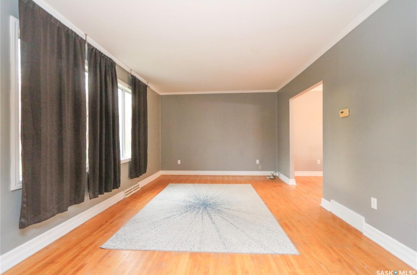 Spare room with wood-type flooring and crown molding