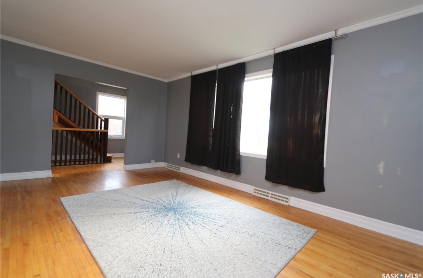 Empty room featuring crown molding and hardwood / wood-style flooring