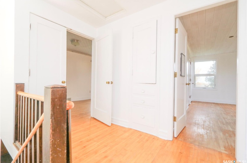 Hallway with hardwood / wood-style floors