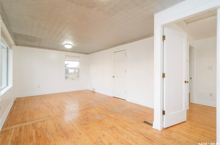 Unfurnished room with hardwood / wood-style flooring and a textured ceiling