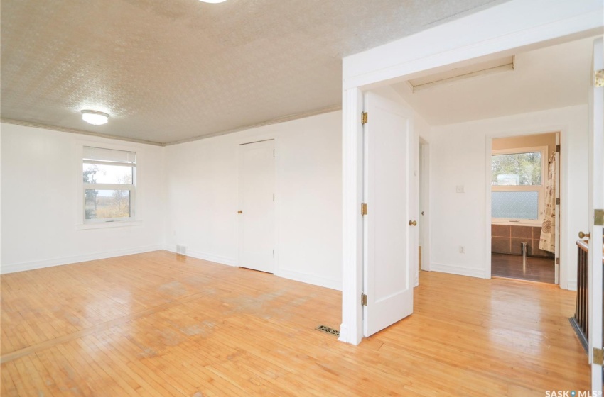 Spare room featuring a textured ceiling and light hardwood / wood-style floors