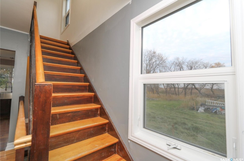 Stairway featuring hardwood / wood-style flooring and sink