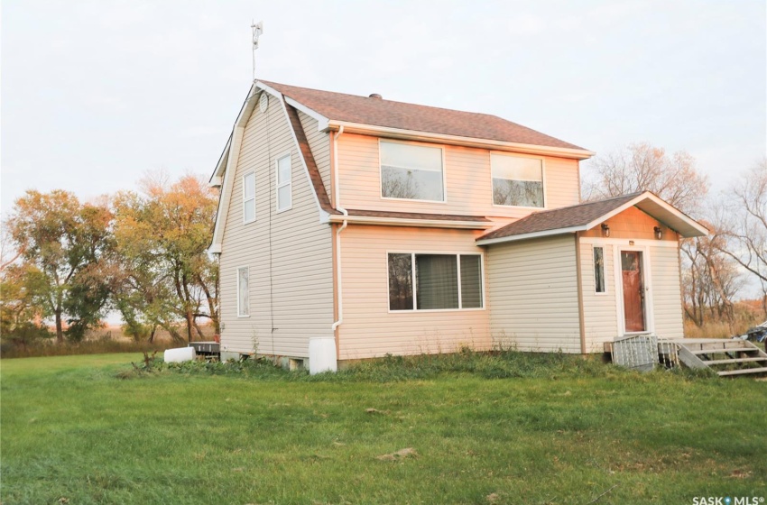 Back of property featuring a lawn