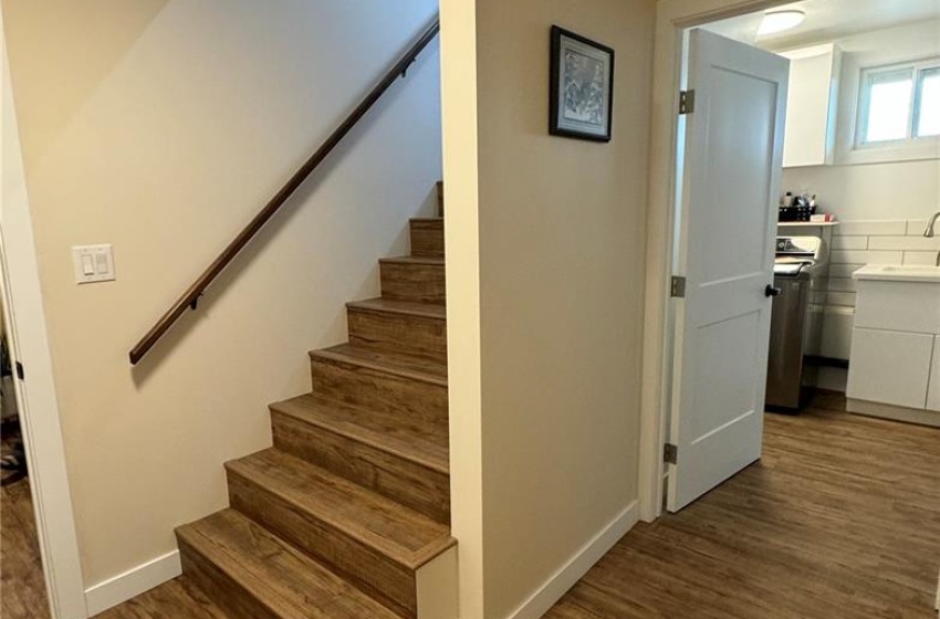 custom built home stairway up to main floor