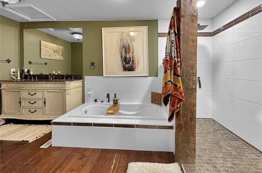 Even the accent tile in the custom tiled bath flows with the homes ranch vibe with weathered wood tile.