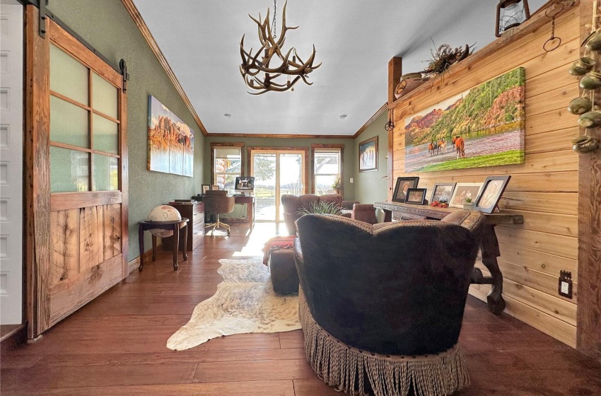 Office/ Sitting area with custom antler chandelier . Note the doors to the almost 2,000 sq ft south facing deck with Moose mountains rolling hills begin for a view.