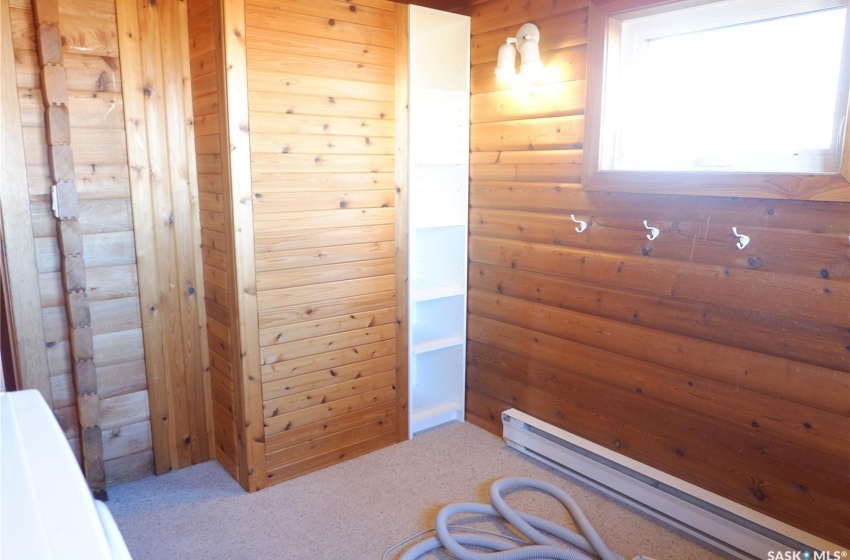 Bathroom with wooden walls and a baseboard heating unit