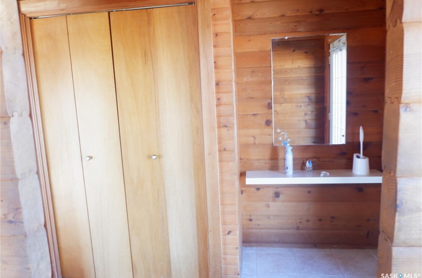 Bathroom featuring tile patterned flooring and wood walls