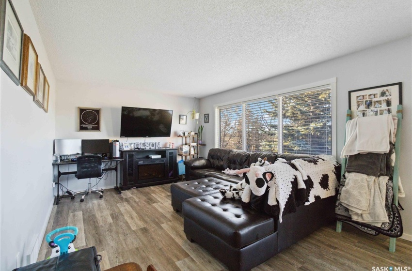 Living room featuring vinyl plank flooring and a textured ceiling