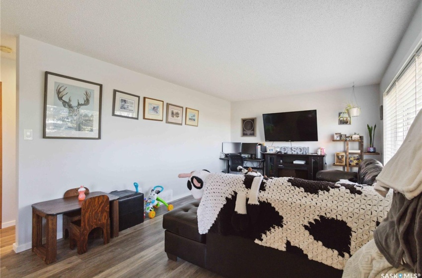 Living room featuring vinyl plank flooring and a textured ceiling