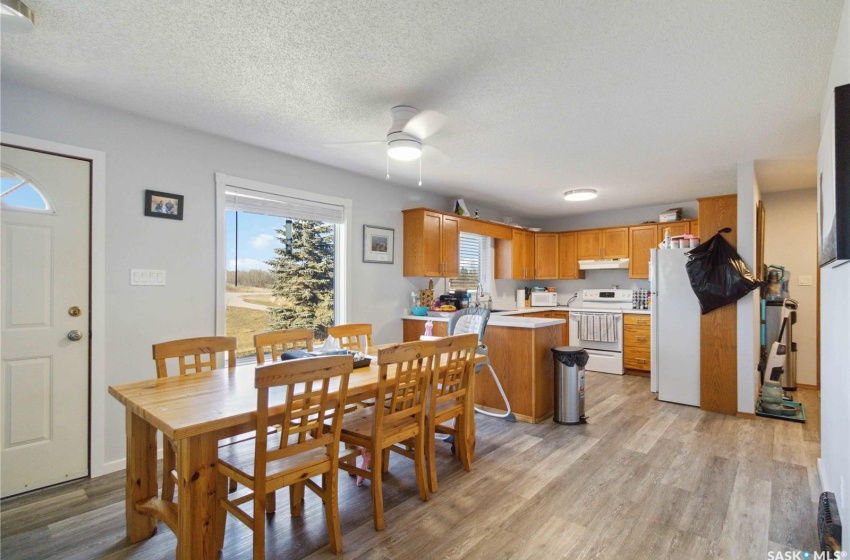 Dining space featuring vinyl plank flooring, a textured ceiling, and ceiling fan