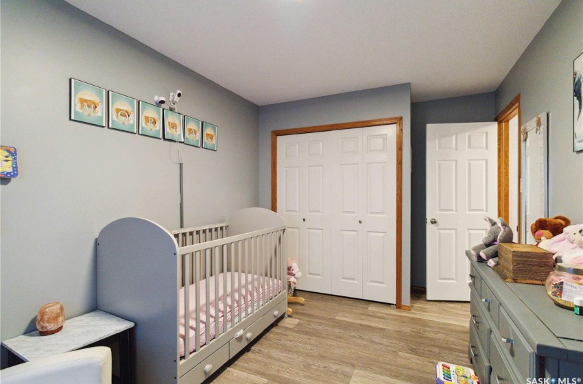 Bedroom featuring vinyl plank flooring, and a closet