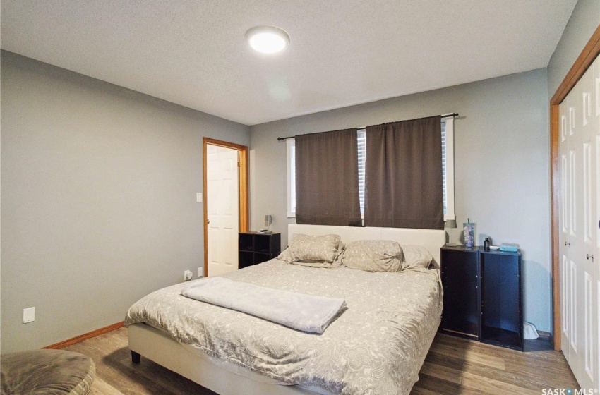 Bedroom with vinyl plank flooring and a closet