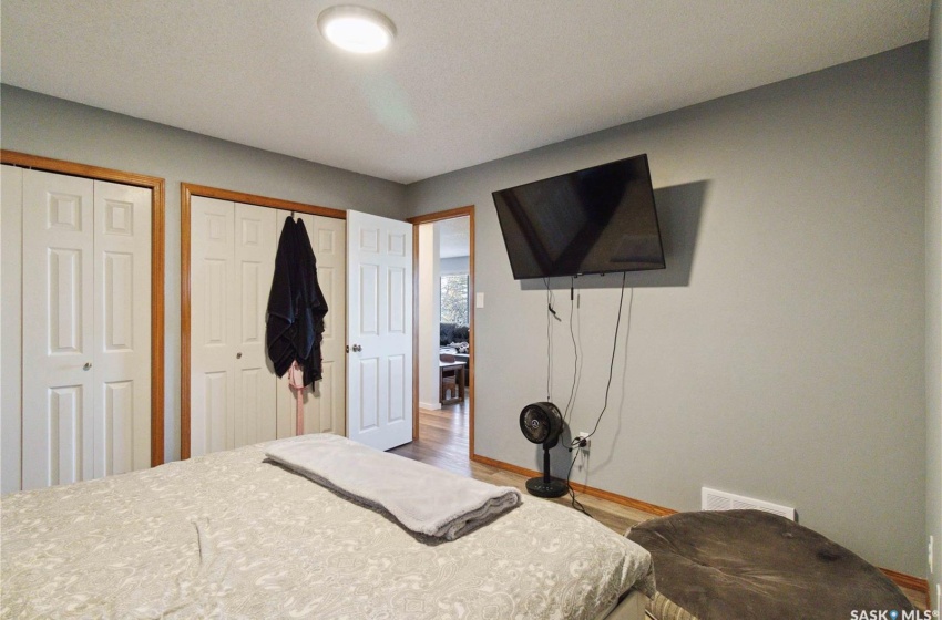 Bedroom featuring vinyl plank floors and two closets