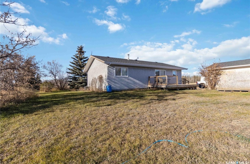 Rear view of property with a wooden deck and a yard