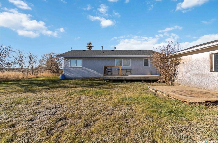 Rear view of property with a yard and a deck