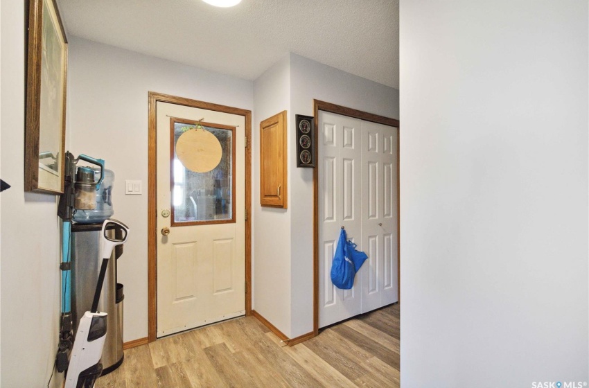 Entryway featuring vinyl plank flooring and a textured ceiling