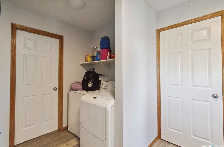 Laundry room featuring vinyl plank flooring and separate washer and dryer