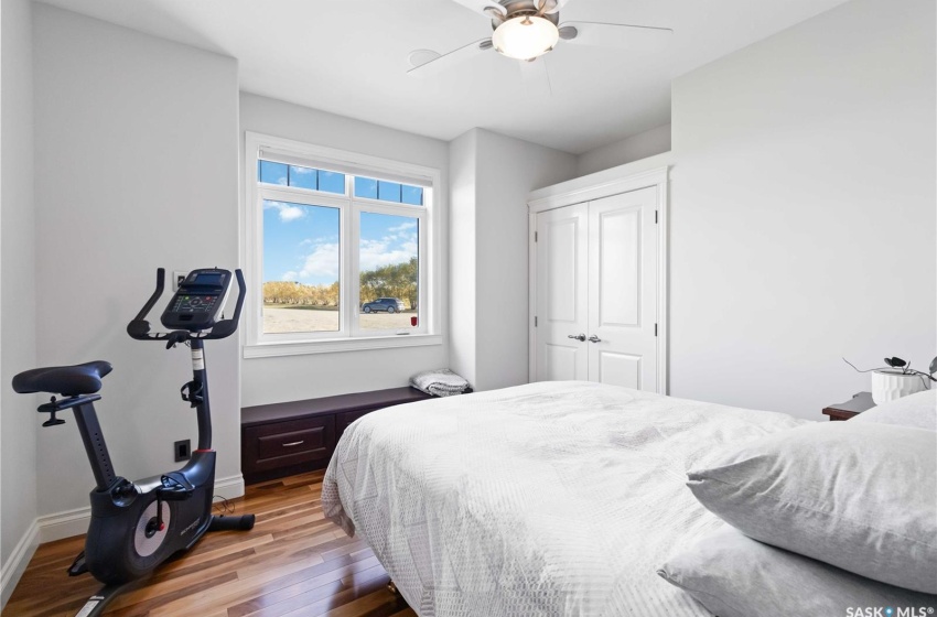 Bedroom featuring wood-type flooring, a closet, and ceiling fan