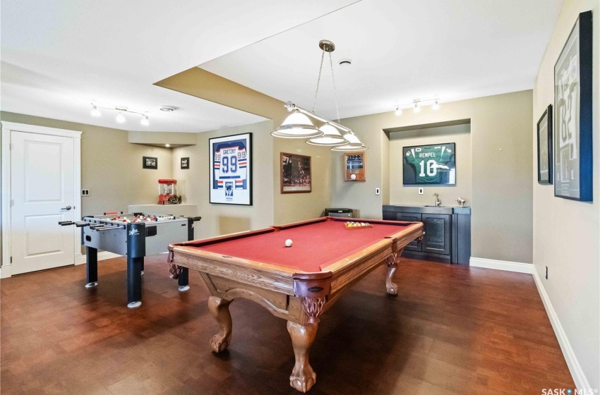 Playroom featuring sink, wood-type flooring, track lighting, and billiards