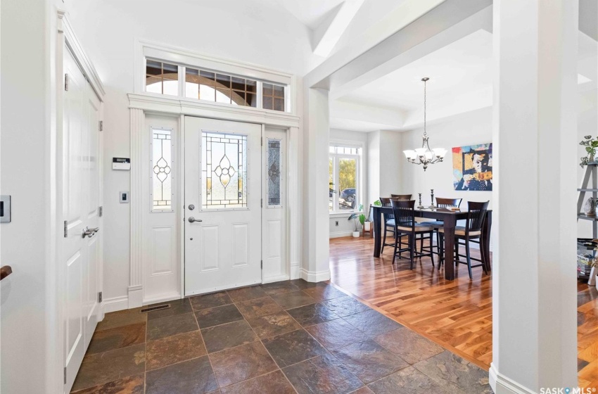 Entrance foyer featuring a chandelier and dark wood-type flooring