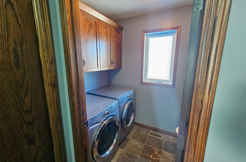 Laundry area with cabinets and washer and clothes dryer