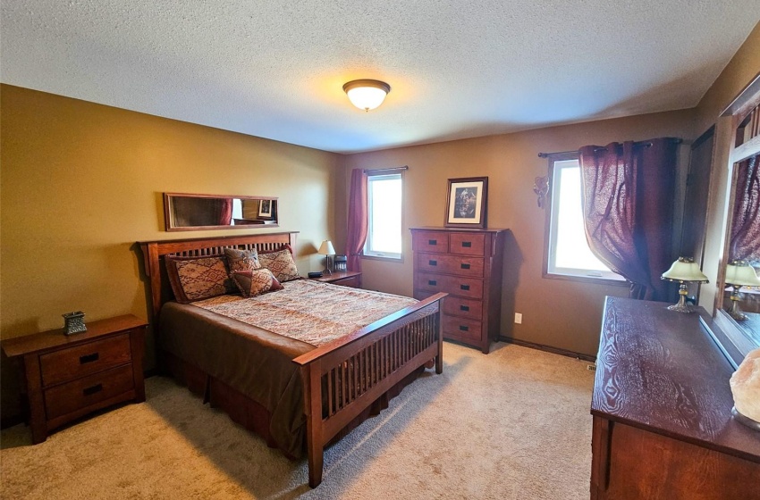 Carpeted bedroom with a textured ceiling