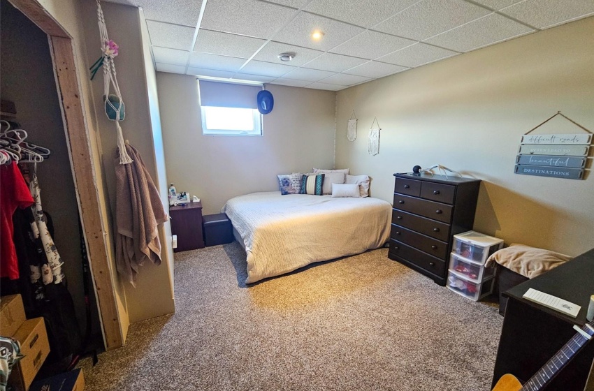 Bedroom with carpet flooring and a paneled ceiling