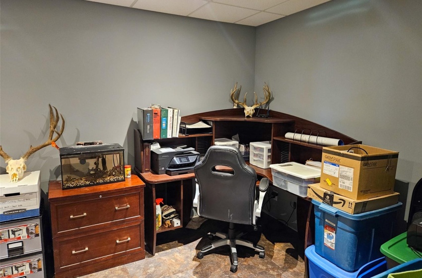 Office with a paneled ceiling