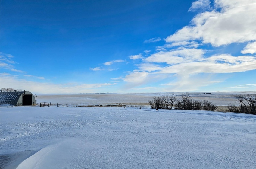 Yard covered in snow with a water view