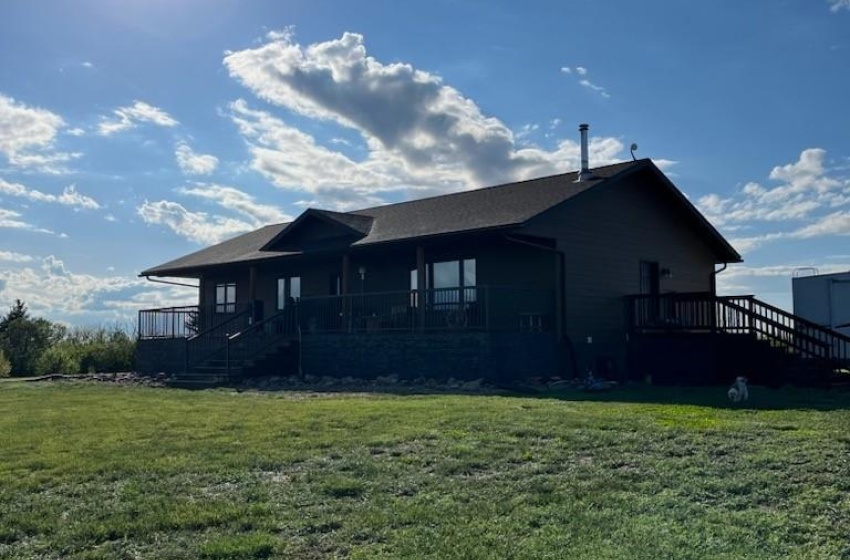 Back of house featuring a yard and a deck