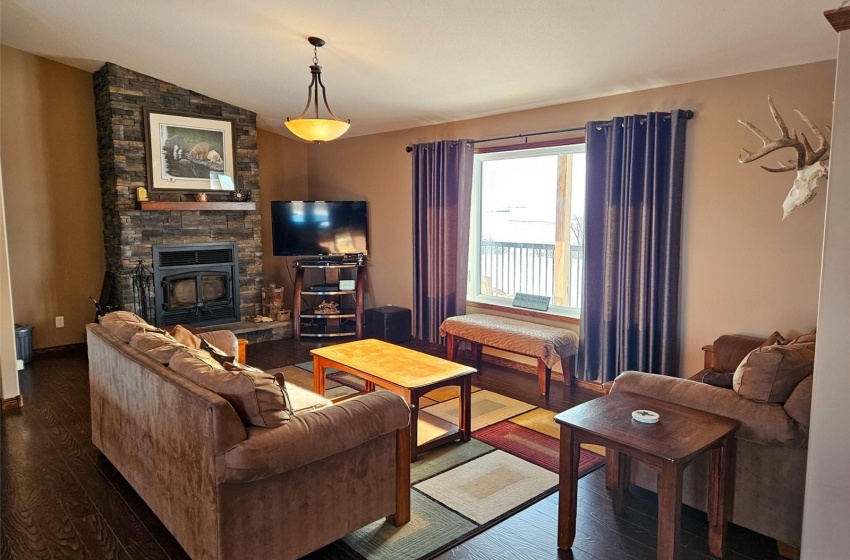 Living room with dark wood-type flooring and lofted ceiling