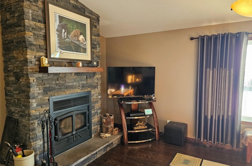 Living room featuring hardwood / wood-style flooring and lofted ceiling