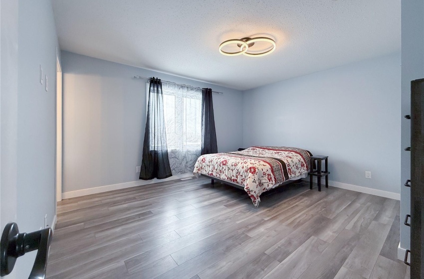 Bedroom with wood-type flooring and a textured ceiling