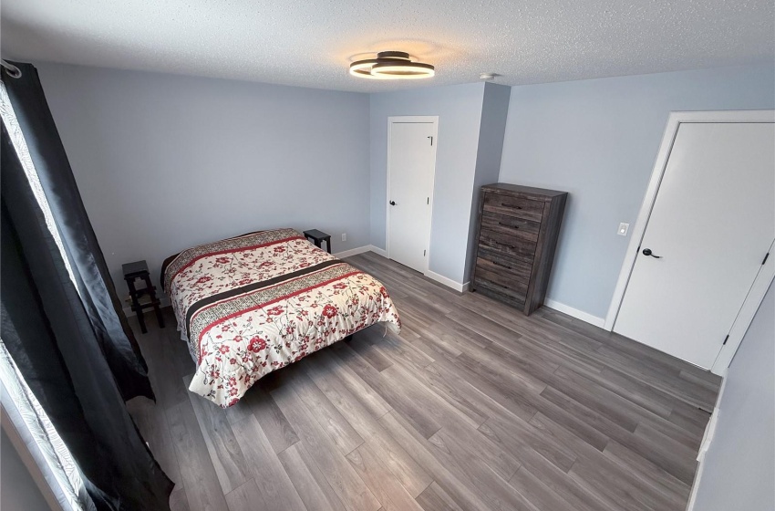 Bedroom featuring wood-type flooring and a textured ceiling