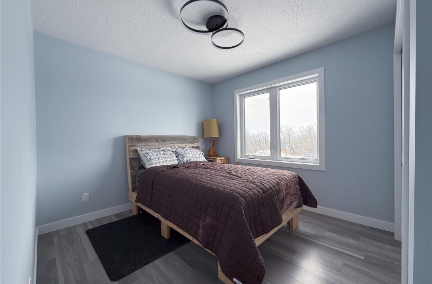 Bedroom featuring wood-type flooring and a textured ceiling