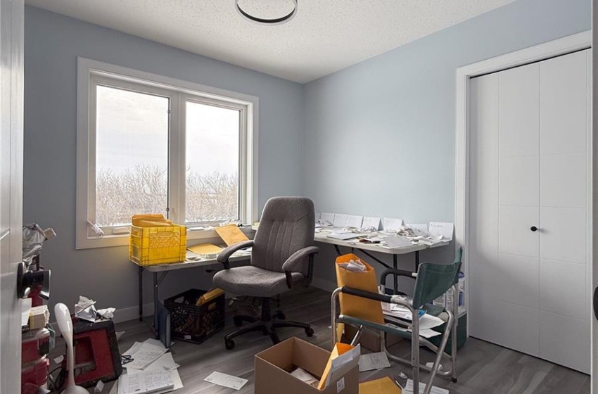 Office space featuring wood-type flooring and a textured ceiling