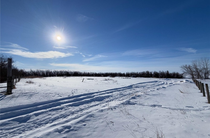 Snowy yard featuring a rural view