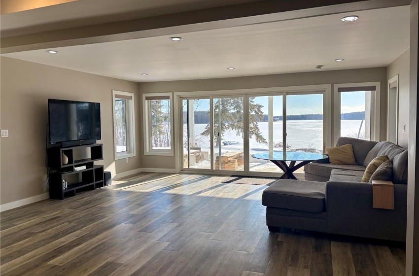 Basement family room with hardwood / wood-style floors and a water view with walkout doors.