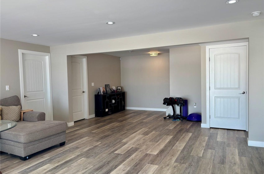 Basement family room featuring hardwood / wood-style floors