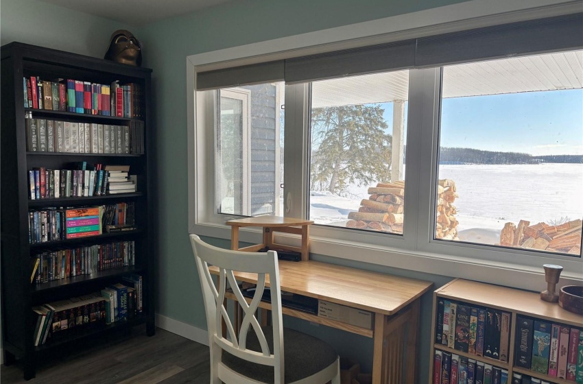 Bedroom with hardwood / wood-style floors and a lake view