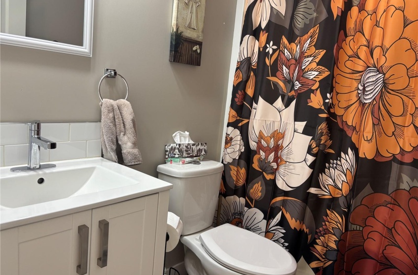 Basement Bathroom featuring vanity and toilet