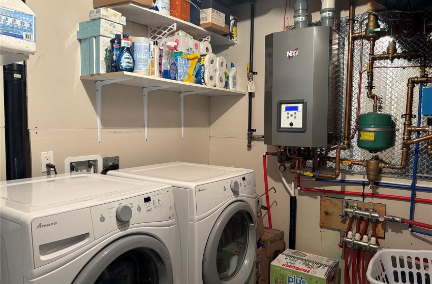 Clothes washing area featuring independent washer and dryer and water heater