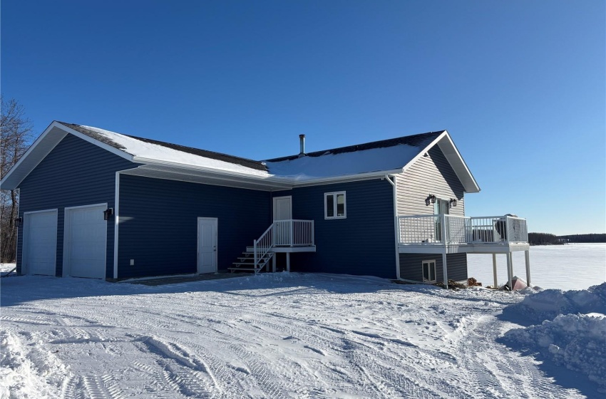 View of snow covered rear of property